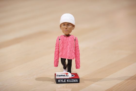 Kyle Kuzma reacts to his pink-sweater bobblehead