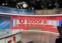 Brandon “Scoop B” Robinson recording an episode of Scoop B Radio in a studio setting.