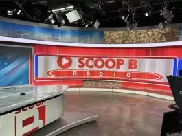 Brandon “Scoop B” Robinson recording an episode of Scoop B Radio in a studio setting.