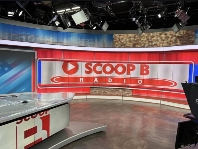 Brandon “Scoop B” Robinson recording an episode of Scoop B Radio in a studio setting.