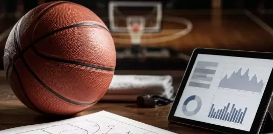 How to Read Basketball Form Before Comparing Betting Markets Basketball, tactic sheet and tablet with charts arranged on a court-side desk
